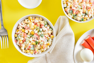 Salad with crab sticks, corn, eggs, cucumber and rice