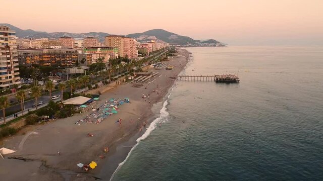 Aerial view of sea coast, sunbeds and umbrellas at beach and hotels. Mahmutlar, Antalya, Turkey