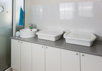 Naklejka na ściany i meble Sink and enameled containers for washing disinfection in the clinic room for processing reusable medical equipment and instruments