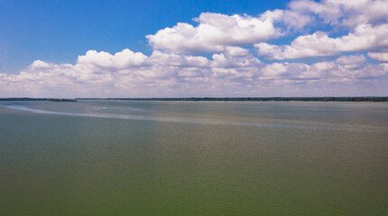 Danube river landscape with white clouds in clear blue sky