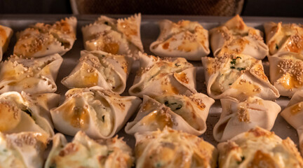 Kalitsounia kaltsounia pies traditional Cretan dough with various herbs mizithra cheese background