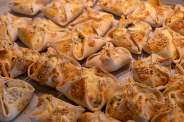 Kalitsounia kaltsounia pies traditional Cretan dough with mizithra cheese background © Rawf8