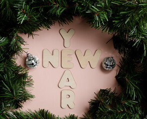 Christmas background. New Year's Eve inscription made of wooden letters with Christmas decorations. frame for text