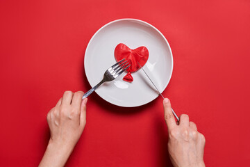 Eating love. Heart shape balloon on the plate. Love eating