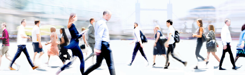 Walking people blur wide background. Lots of people walking in the City. Business concept...