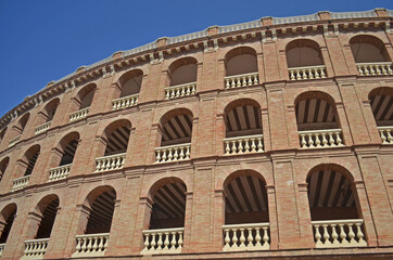 Fototapeta na wymiar brick arena with arches and decorative parapets