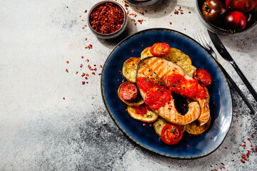 beautiful salmon fillet with tomato sauce and potatoes