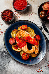 beautiful salmon fillet with tomato sauce and potatoes
