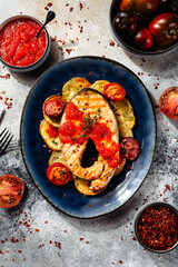 beautiful salmon fillet with tomato sauce and potatoes