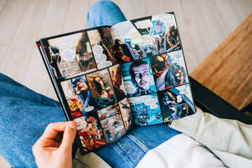 Fototapeta premium Man reads comic book in living room at home. Rostov-on-Don, Russia. 8 September 2021