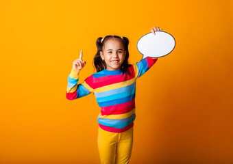 portrait of a little girl holding an empty paper cloud pondering an idea.