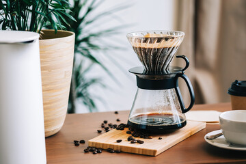 Alternative coffee brewing method, using pour over dripper and paper filter. - Powered by Adobe