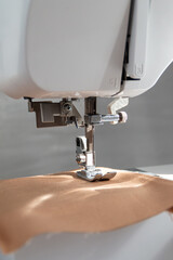 sewing machine close up view with natural sunlight, slow fashion and home sewing concept
