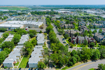 Obraz premium Aerial view of the residential area of beautiful suburb of home dwelling and road from a height.