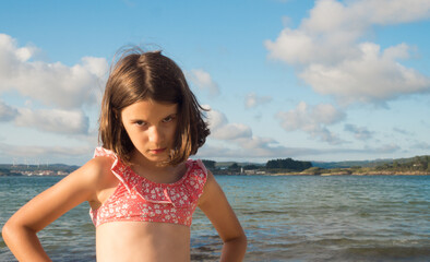 Portrait of a Caucasian girl with angry gesture on the beach