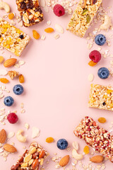 Granola bars. Healthy energy bars made of cereals, berries, nuts and fruits on a light pink background. Space for the text. Top view.