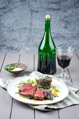 Traditional dry aged barbecue wagyu entrecote beef steak coated in sage leaves and served as close-up on a classic design plate