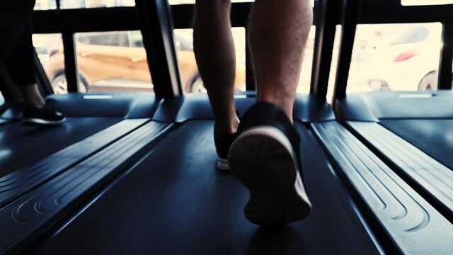 Close Up athlete's foot running on treadmill. legs having workout on treadmill.