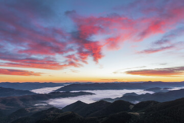 Sunrise on the foggy morning. Landscape with high mountains. Panoramic view. Forest of the pine trees. Touristic place. Natural scenery. Location Carpathian, Ukraine, Europe. Wallpaper background.
