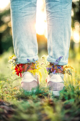Beautiful wildflowers in shoes on a summer field. Summer background