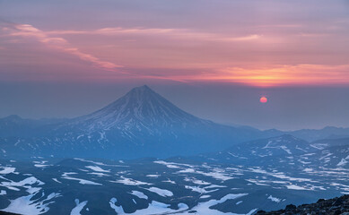 Fototapeta na wymiar Sunrise from the top of the Gorely volcano and view to the Vilyuchinsky volcano in the Kamchatka Peninsula , Russia.