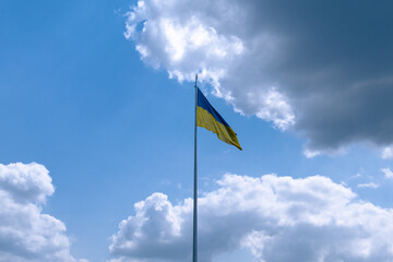 Flag of Ukraine on a background of blue cloudy sky. Flag of the Ukrainian state