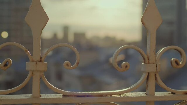 A cinematic shot of the city in the rays of the setting sun.