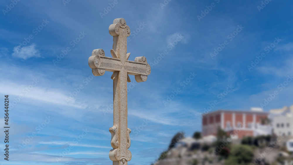 Sticker White stone cross with the sky on the background