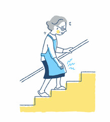 膝の痛みを我慢しながら階段を上る女性