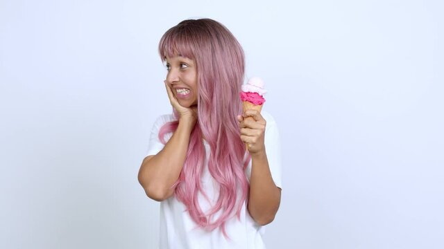 holding a cornet ice cream with surprise and shocked facial expression over isolated background