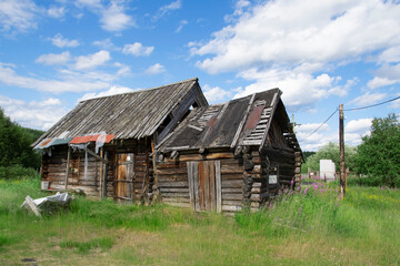 Fototapeta na wymiar Kola peninsula, Russia - July 10, 2021: Old destroyed abandoned wooden country building