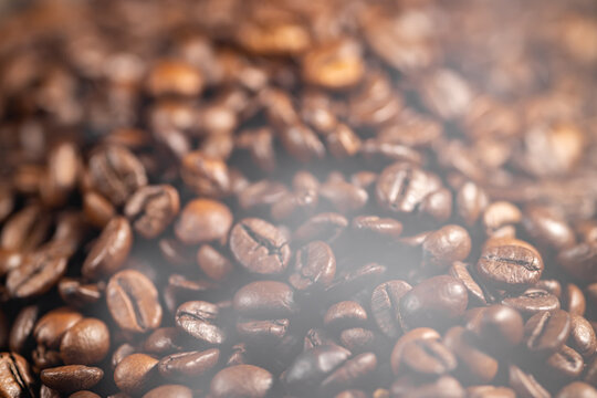Blurred coffee background, roasted coffee seeds blurred with hot steam