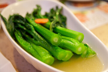 Morning tea dim sum, boiled water vegetables on the plate, Chinese Cantonese cuisine, healthy food