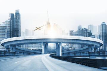 Suspension bridge connect to highway concrete road curve,Highway overpass motion with modern city background , blue tone