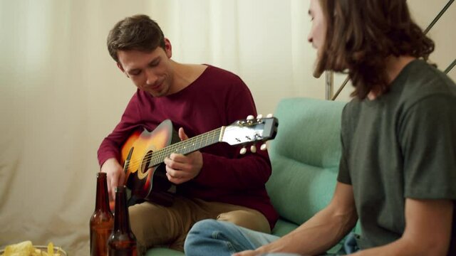 Two friends are playing guitar and singing songs