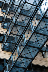 Lattice metal walkways between two modern buildings.