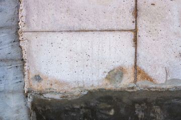 Repair with cement of a wall, parts of the concrete still wet on the wall.