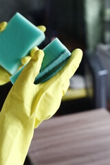 Closeup hand in glove with sponge cleaning the room housework health cleaner home housekeeping domestic service worker hygiene wash mirror