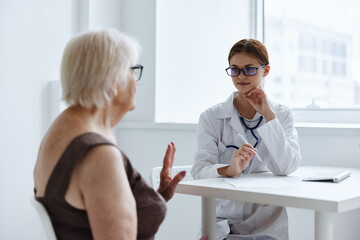 elderly woman talking to the nurse doctor assistant