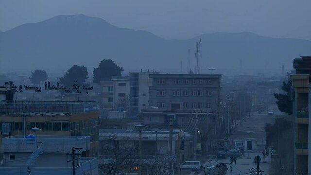 Afghanistan scene - early evening scene from Kabul city - with buildings and  a busy street with traffic and people