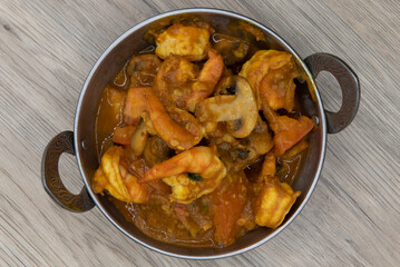 Overhead view of Indian flavored mushroom shrimp meat in a bowl from Indian restaurant cooked and...