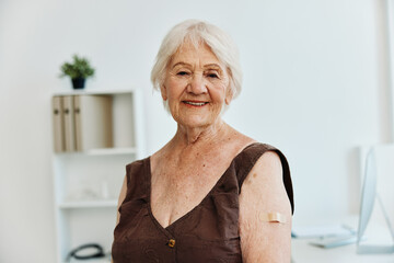 elderly woman with a plaster on her arm vaccine passport immunity protection