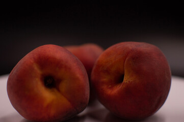 Peaches on a white dish with background