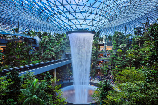 Singapore - July 24, 2019: The world's tallest indoor waterfall, named the Rain Vortex, which is surrounded by a terraced forest setting at Jewel Changi Airport, Singapore.