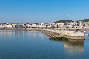 The wharf of the fishing village and the dam made of stones