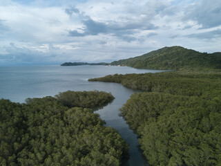 Brackish water estuaries and inlets dot the shoreline of Paquera Costa Rica as they are fed from the clear rich waters of the Gulf of Nicoya from an aerial drone view