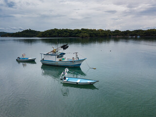 Ocean going fishing boats sit moored off a small island in the Gulf of Nicoya Costa Rica from an Aerial drone