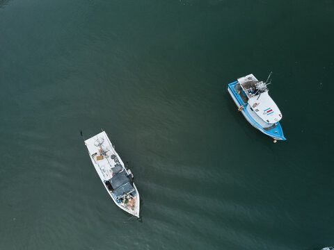 Costa Rican Fishermans boats in the water as seen from an aerial drone image perspective