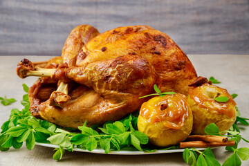 Roasted turkey garnished with caramel apples and clover leaves.