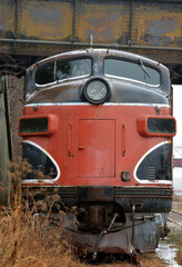 Front end view of an old abandoned locomotive in a train yard